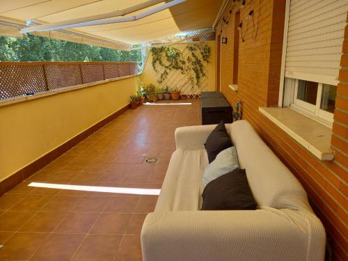 a living room with a couch on a balcony at Piso acogedor con terraza in Ciudad Real