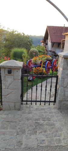 a black fence with a bunch of flowers on it at Apartmani Mali Raj Rudnik in Rudnik Kačerski