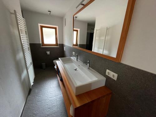 a bathroom with a sink and a mirror at Oberfahrerhof in San Genesio Atesino