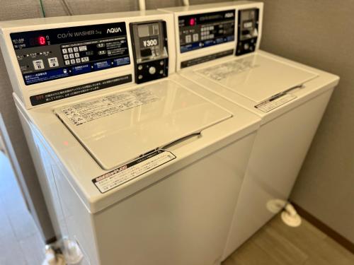 two machines are sitting next to each other at TenTen Guesthouse in Asakusa in Tokyo
