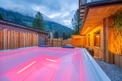a swimming pool in the middle of a house at AlpinSpa zur Post - Bergbahn im Sommer 2025 inklusive in Bad Gastein