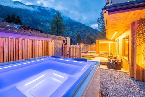 a swimming pool in the backyard of a house at AlpinSpa zur Post - Bergbahn im Sommer 2025 inklusive in Bad Gastein