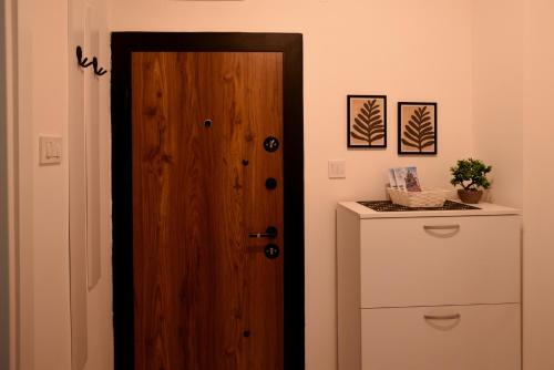 a wooden door in a room with a refrigerator at Apartment 863 in Bitola