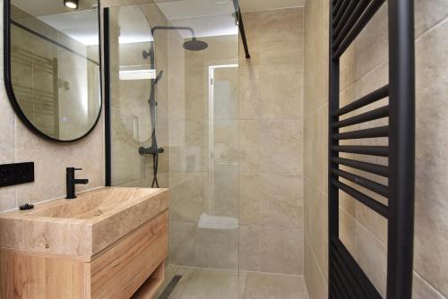 a bathroom with a sink and a shower at Boutique Scheveningen beach apartment in Scheveningen