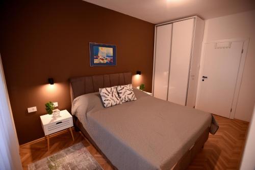 a small bedroom with a bed and a white closet at Apartment 863 in Bitola