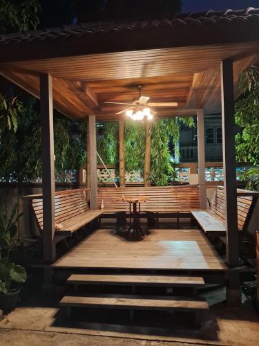 a pavilion with benches and a table and chairs at Rabbit House in Ban Han Tra Fang Nua