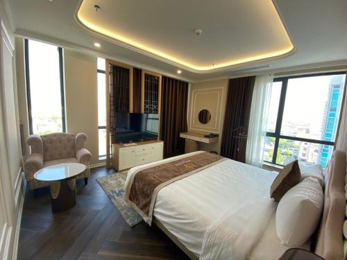 a bedroom with a large bed and a television at Riverside Hotel Hà Nam in Phủ Lý