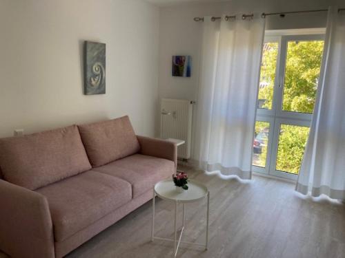 a living room with a couch and a table at Kleine Galerie in Schönberger Strand