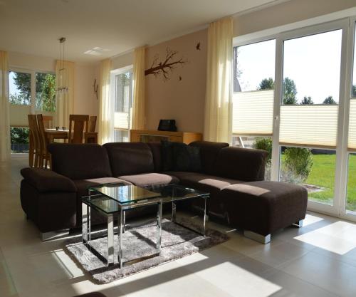 ein Wohnzimmer mit einem Sofa und einem Glastisch in der Unterkunft Kira in Schönberger Strand