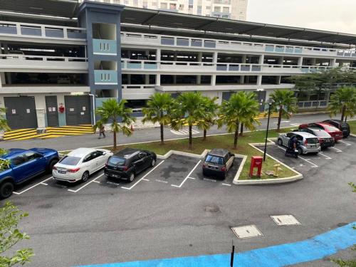 a parking lot with cars parked in front of a building at YAYA HOMESTAY CYBERJAYA & PUTRAJAYA in Cyberjaya