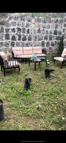 a group of benches sitting in the grass at Kirovakan Vacation House in Vanadzor