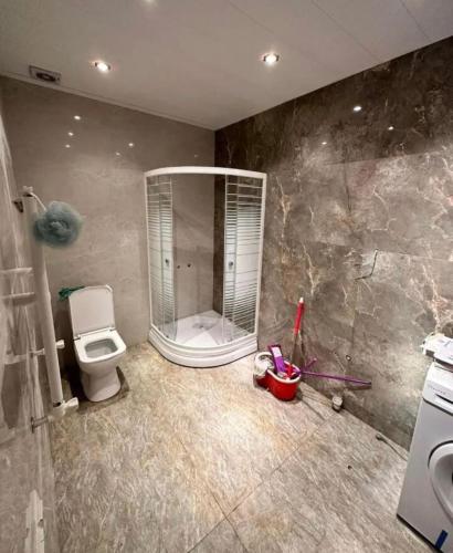 a bathroom with a shower and a toilet in it at Kirovakan Vacation House in Vanadzor