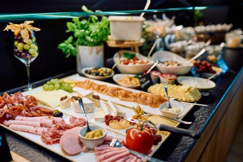 a buffet with many different types of food on a table at Hofgut Wißberg - Das Weinberghotel in Sankt Johann