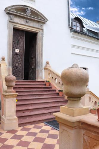 a building with a wooden door and stairs at Karczówka Klasztor in Kielce