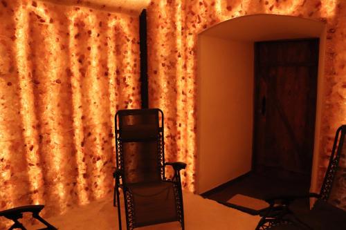 a room with two chairs and a wall with a curtain at Karczówka Klasztor in Kielce