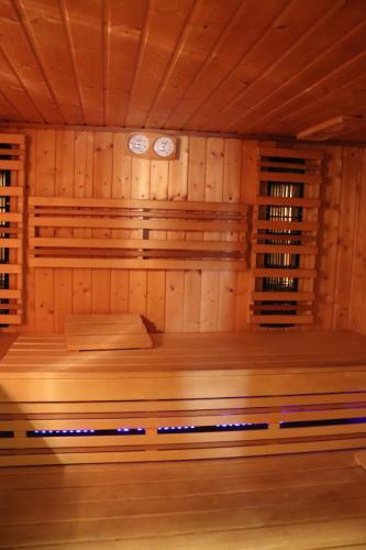 a room with a sauna with two clocks on the wall at Karczówka Klasztor in Kielce