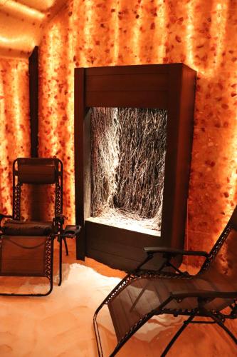 a chair and a mirror on a wall with a haystack at Karczówka Klasztor in Kielce