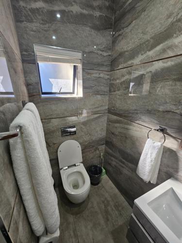 a bathroom with a toilet and a sink at Casa De Luxe in Ballito