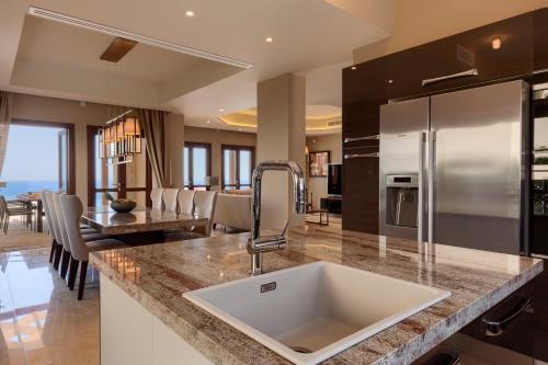 a kitchen with a sink and a counter top at Aphrodite Hills Rentals - Mythos Collection Villas in Kouklia