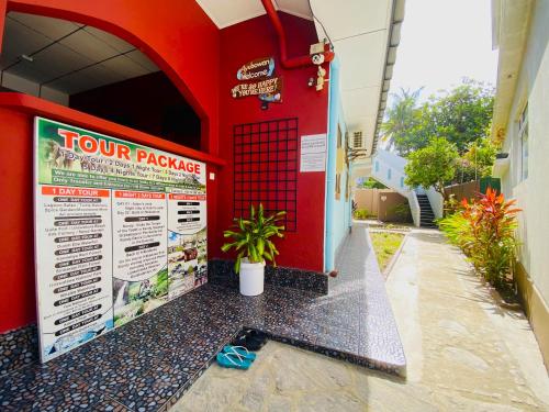a tour package sign on the side of a building at Tamara Motels in Hikkaduwa