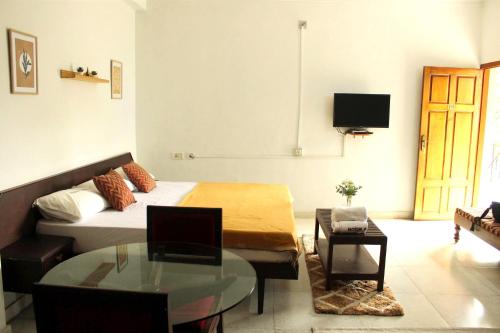 a living room with a bed and a coffee table at Noor Plaza in Angamali