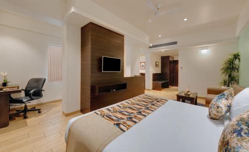 a hotel room with a bed and a desk and a television at The Fern Kesarval Hotel & Spa, Verna Plateau - Goa in Verna