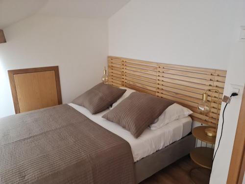 a bedroom with a large bed with a wooden headboard at La Factory in Porrentruy