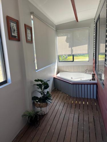 a bathroom with a bath tub and a window at Thie My Chree Retreat in Herne Hill