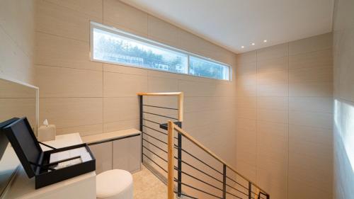 a room with a staircase with a desk and a window at Milos Pool Villa - K102 in Yeosu