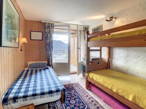 a bedroom with two bunk beds and a window at Séracs 35*** in Verbier