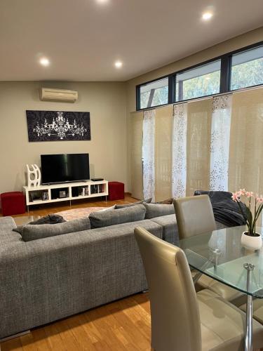 a living room with a couch and a table at Thie My Chree Retreat in Herne Hill