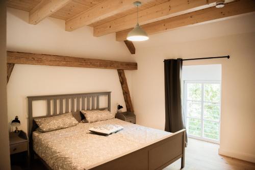 a bedroom with a bed and a large window at Zauberhafte Ferienscheune im Hofgut Alte Ölmühle in Engen
