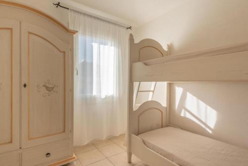 una camera bianca con letto a castello e finestra di Elegant Residence Ea Bianca 2 Bedroom sleeps 6 plus extra bed available no0715 a Cala Bitta