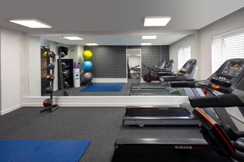 a gym with treadmills and elliptical machines at Crowne Plaza Harrogate by IHG in Harrogate