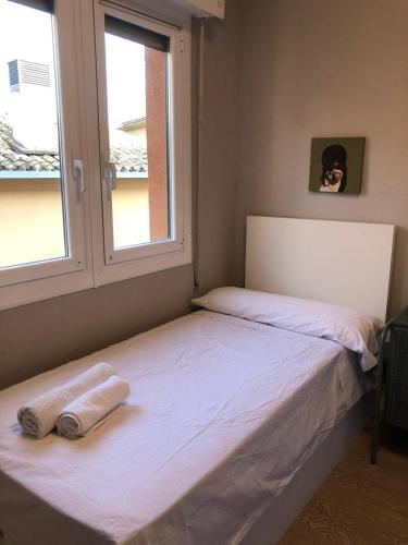 ein Bett mit zwei Handtüchern darauf in einem Schlafzimmer in der Unterkunft Habitación Doble en el centro - Apartamento in Estella