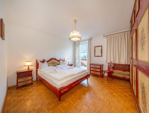 a bedroom with a bed and a large window at Villa Suredl in Ortisei