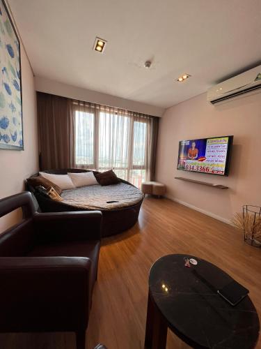 a living room with a couch and a tv at 3415B Mipec Riverside nice view in Hanoi