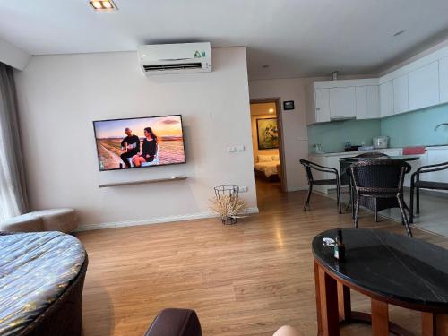a living room with a tv on a wall at 3415B Mipec Riverside nice view in Hanoi