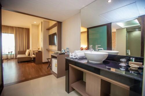 a bathroom with a sink and a large mirror at Chiangmai Grandview Hotel & Convention Center - SHA Extra Plus in Chiang Mai