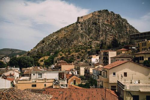 a town with a mountain in the background with houses at Gambello Luxury Rooms in Nafplio