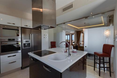 a kitchen with a sink and a counter top at Aphrodite Hills Rentals - Mythos Collection Villas in Kouklia