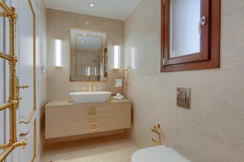 a bathroom with a sink and a mirror at Aphrodite Hills Rentals - Mythos Collection Villas in Kouklia