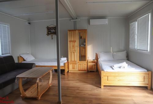 a room with two beds and a couch and a table at Rich Avdira Beach in Ávdhira