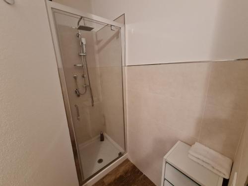 a shower with a glass door in a bathroom at Monti Guest House Alghero in Alghero