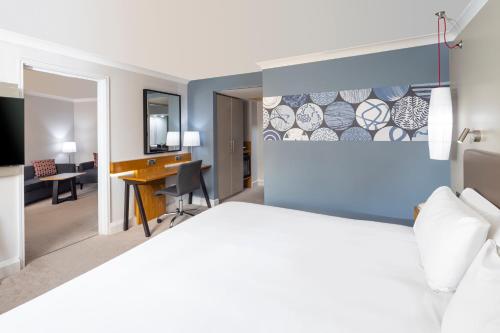 a hotel room with a bed and a desk at Crowne Plaza Harrogate by IHG in Harrogate