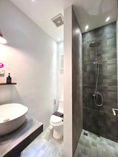 a bathroom with a sink and a toilet and a shower at oxy suites 1-01B at Shop House Meisterstadt Pollux Habibie in Batam Center