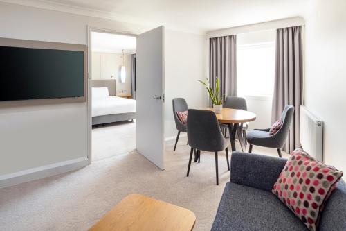 a living room with a couch and a table at Crowne Plaza Harrogate by IHG in Harrogate