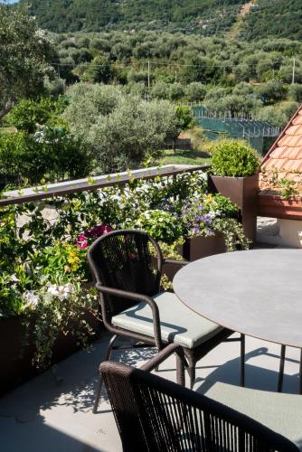 a patio with a table and chairs and flowers at Gargiulo Resort in Sant'Agnello