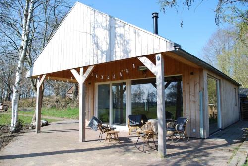 a pavilion with chairs sitting outside of it at Vrijstaande woning Drenthe bij het bos. in Bovensmilde