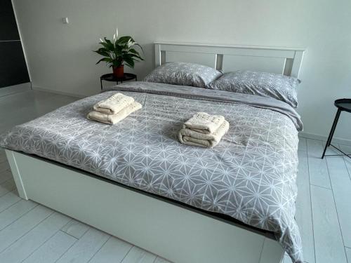 a bedroom with a bed with two towels on it at RUMAKO apartments in Prague